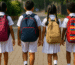 Sri Lankan school children walking to school with colorful backpacks, bright morning light, 2025 hero banner style
